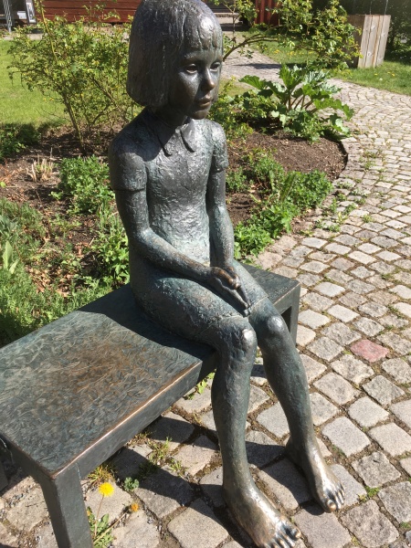 A statue of a sitting girl in Eksjoe