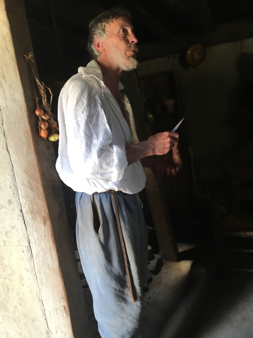 At the Plimoth Plantation Museum. 17th-Century English Village. A role-playing staff.